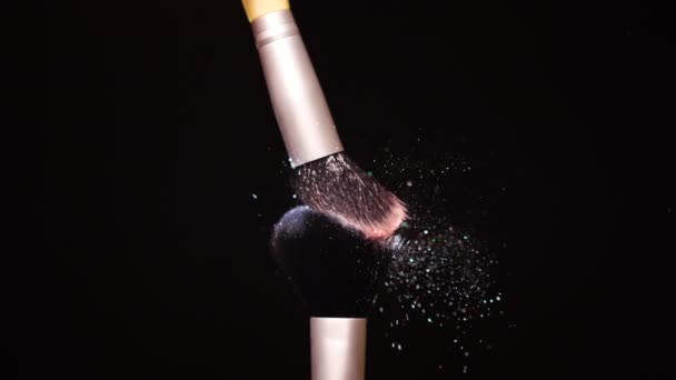 Make up brush with colored powderon at black background Slow Motion — Stock Video