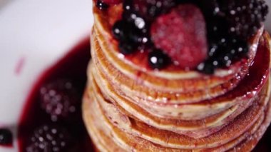 Tatlı böğürtlenli krep, lezzetli kahvaltı, şuruplu krep yığını.