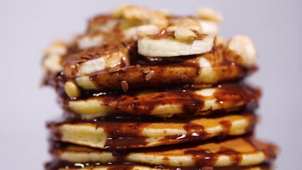 Pancakes with Chocolate, Cacao, Nuts and Bananas. Tasty breakfast, food. — Stock Video