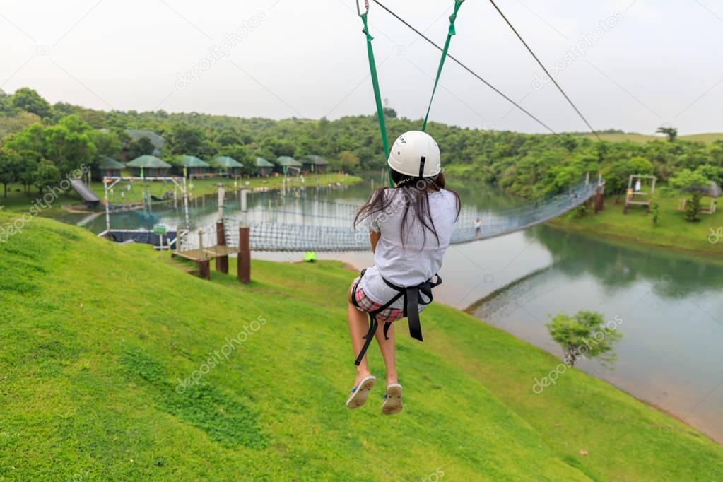 Apr 23, 2017 Woman sliding on a zip line adventure at Mountain