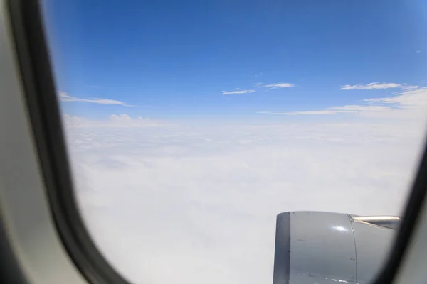 Looking through window aircraft during flight in wing with a blu — Stock Photo, Image