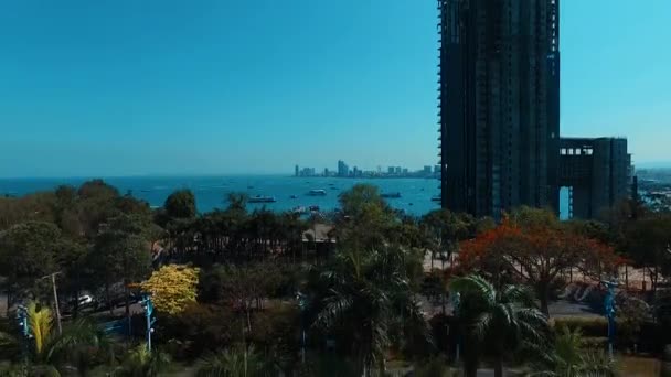 Aerial: Takeoff near Pattaya bay and high rise. — Stock Video
