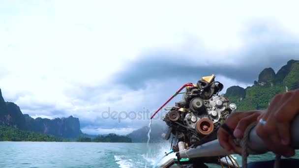 Close up of a boatmans hands driving the longtail boat with a big motor engine. — Stock Video