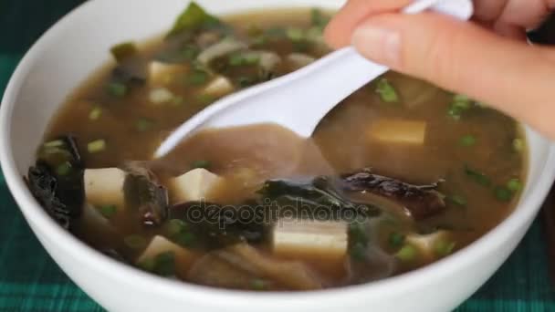 Spooning out miso soup ingredients — Stock Video