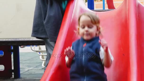 Funny toddler slides down and pouts — Stock Video
