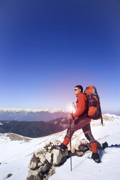 Winterwandelen in de bergen met een rugzak. — Stockfoto