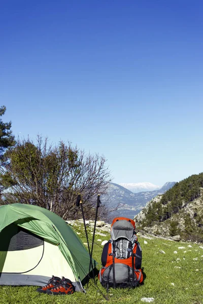 Camping with a backpack and a tent in the mountains.
