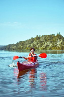 Nehir boyunca ormanda yaz boyunca kano gezisi.