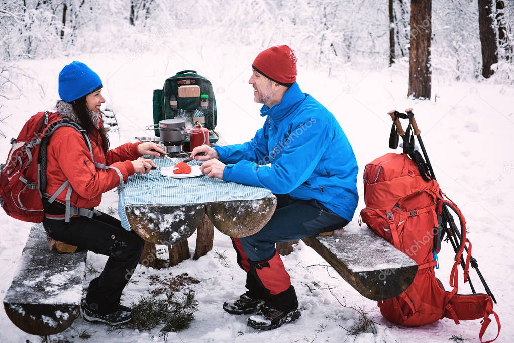 Preparing the meal in the winter hike at the table in the campsi
