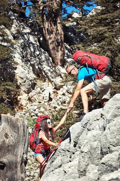 En hjälpande hand för en flicka höga berg i en vandring. — Stockfoto