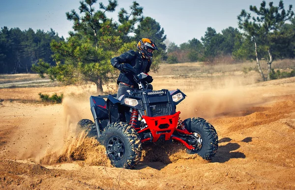 Racing powerful quad bike on the difficult sand in the summer.