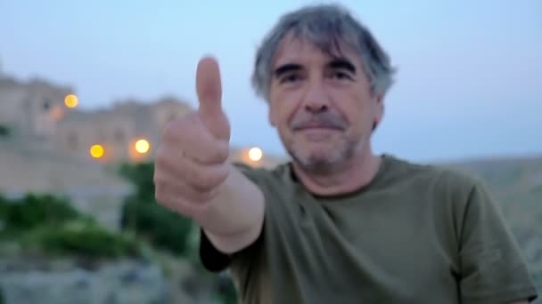 Man 50 years old  thumbs-up to the camera — ストック動画