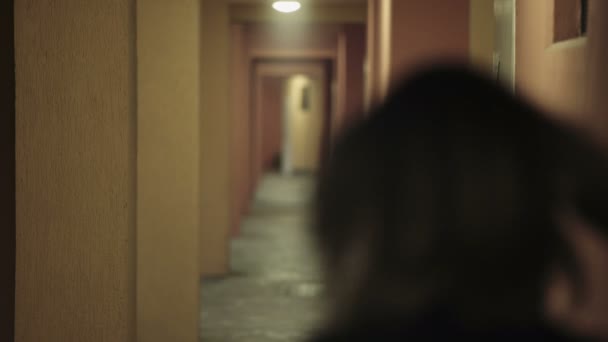 Young woman walking on a hotel corridor and is attacked by a kidnapper — Stock Video