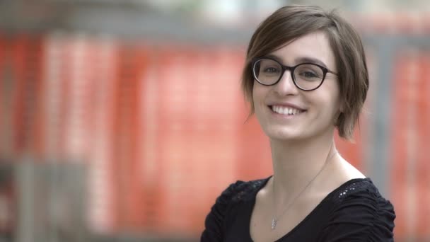 Mulher intelectual vira a cabeça e faz um grande sorriso para a câmera — Vídeo de Stock