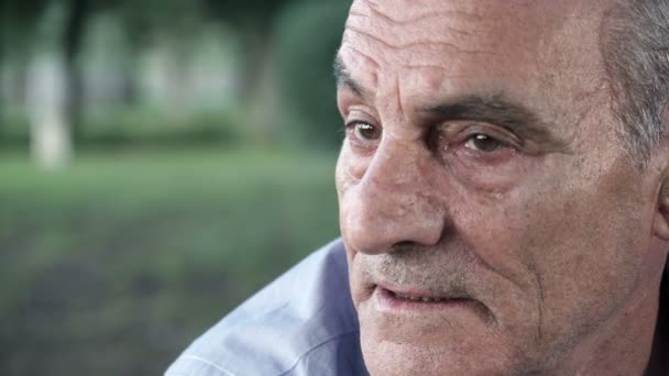 Depressed older man looks at the camera sadly — Stockvideo