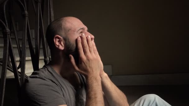 Depressed man sitting on the stairs — Stock Video