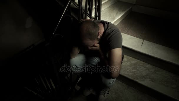 Junkie in withdrawal sitting alone on the stairs waiting for his drug dealer — Stock Video