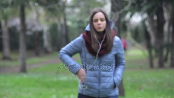 Young girl talking with earphones — Stock Video