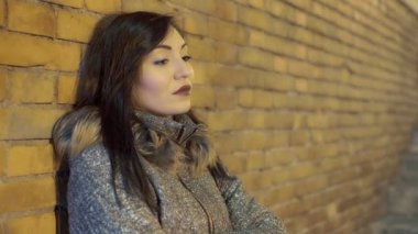 Üzgün kadın duvara yaslanmış