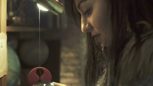 Νεαρή γυναίκα κοιτάζει μια παλιά πυξίδα στα χέρια της — Αρχείο Βίντεο