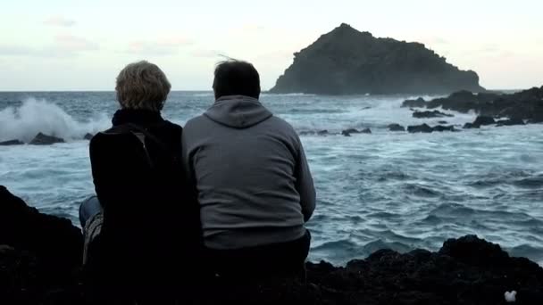 Pareja madura abrazándose viendo el mar durante un día nublado — Vídeos de Stock