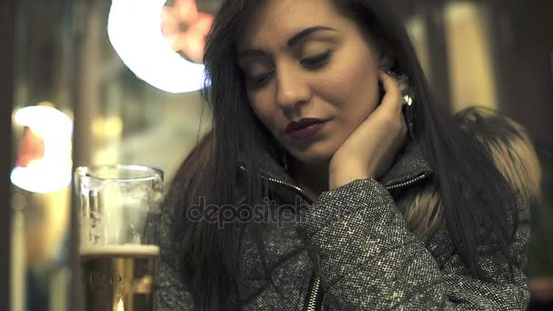 Lonely young woman with glass of beer — Stock Video