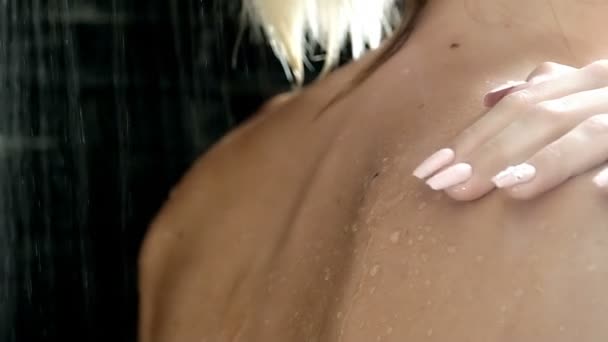 Sexy woman in the shower touching her back — Stockvideo