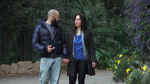 Engaged couple at the park begins a lively discussion — Stock Video