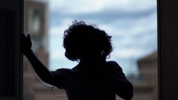 Dancer silhouette dancing in front of the window — Stock Video