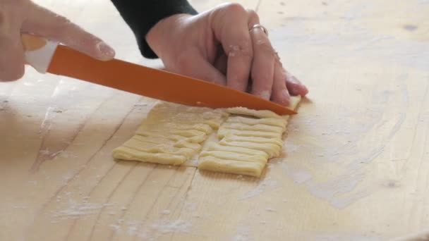 Sapiente mano tagliando pasta fresca per fare le fettuccine — Video Stock