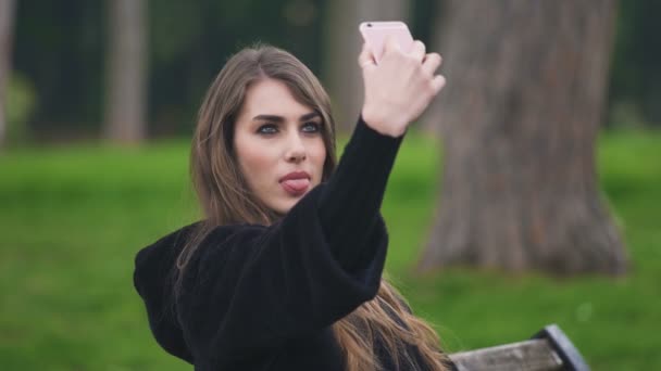 Belle femme au parc tire selfies drôles, portrait — Video