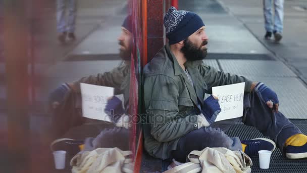 Sad Beggar profile begs alms in the street — Stock Video