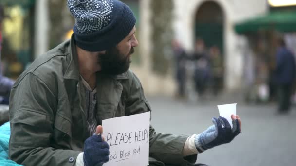 Szomorú, depressziós hajléktalan azt kérdezi az utcán pénzt, valaki ad neki egy érme — Stock videók