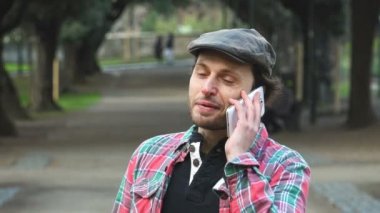 Adam telefonda konuşurken Park'ta gülümseyen