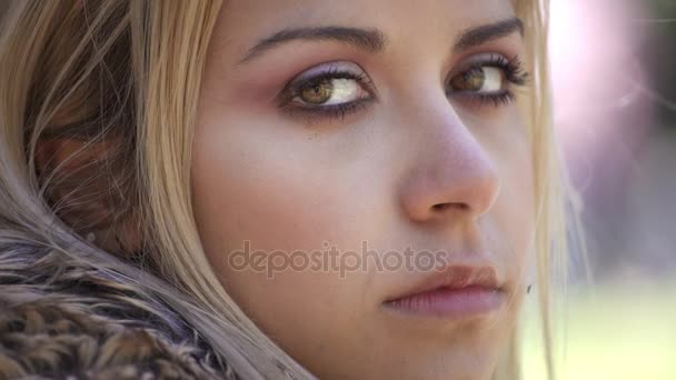 Beautiful young girl looks at the camera and closes her eyes — Stock Video