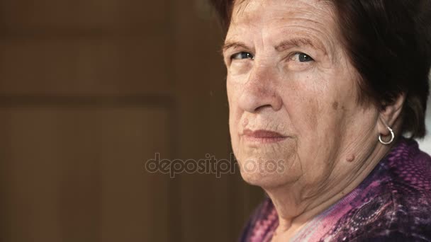 Serious and proud old woman stares the camera — Stock Video