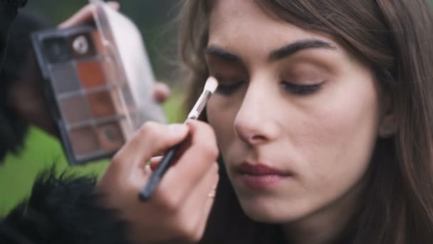 Maquiagem artista aplicando sombra com um pincel no olho da mulher — Vídeo de Stock