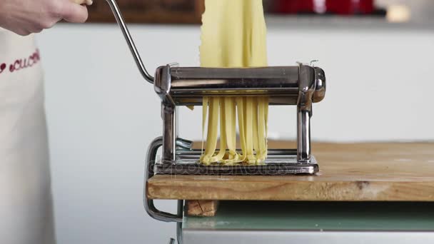 Making fettuccine: cutting dough with machine — Stock Video