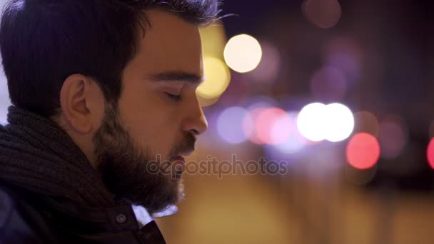 Worried thoughtful young man's profile at night in town — Stock Video