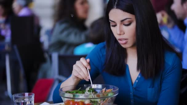 Thoughtful and lonely filipino Woman Eating salad sitting in a restaurant — Stock Video