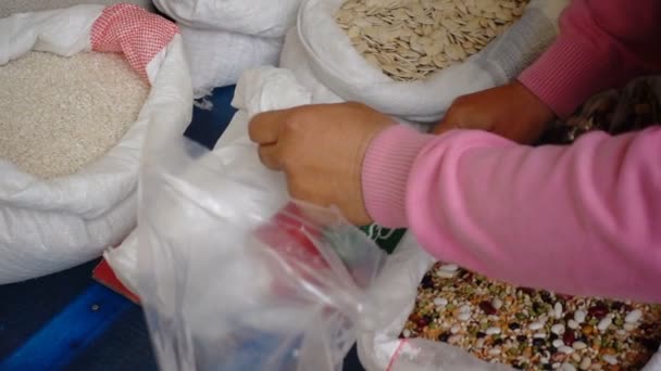 Close up on Old farmer puts chickpeas in the envelope — Stock Video