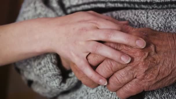 Zärtlichkeit in der Familie: Hand des Enkels streichelt die Hände des alten Opas am Stock — Stockvideo
