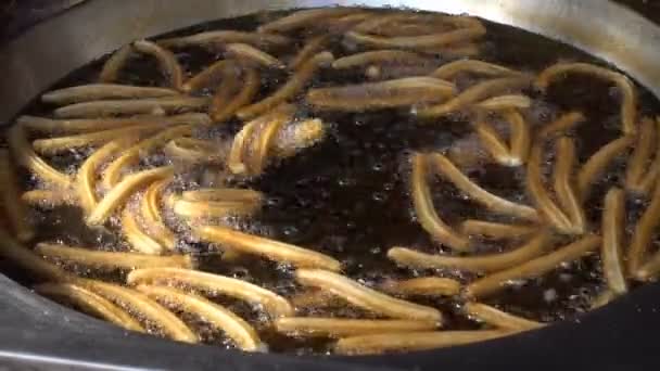 Churros fry in the oil — Stock Video