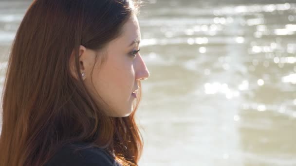 Relaxed Young Woman Contemplates River Sunny Day — Stock Video