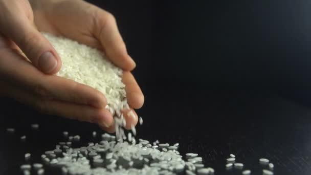 Female hands pours rice grain. Slow motion — Stock Video