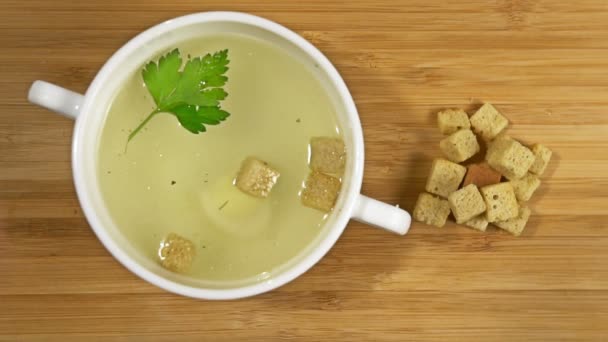 Croutons falls into chicken soup Slow motion — Stock Video