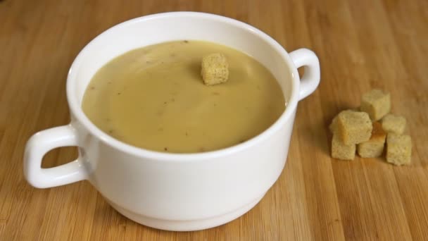 Crouton fall in mushroom cream soup Slow motion — Stock Video