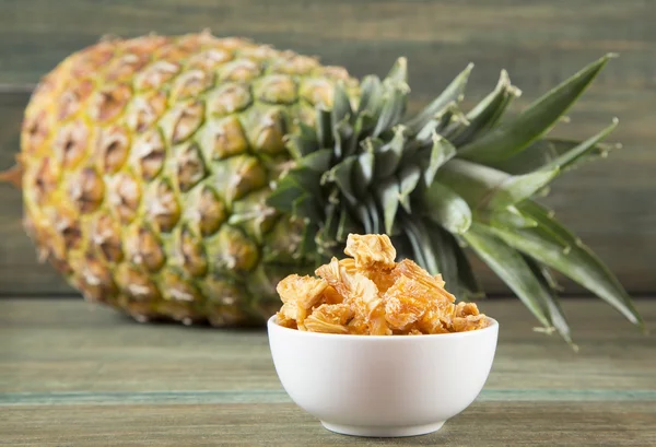 Dried pineapple on wooden background