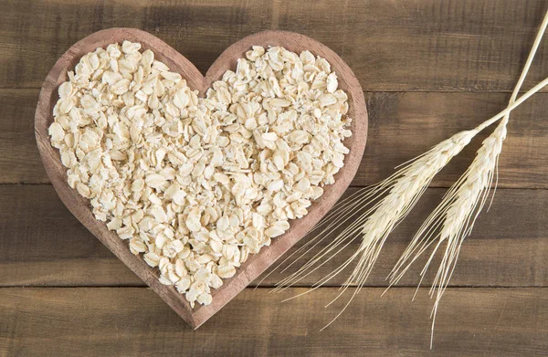 Rolled oats in heart — Stock Photo, Image