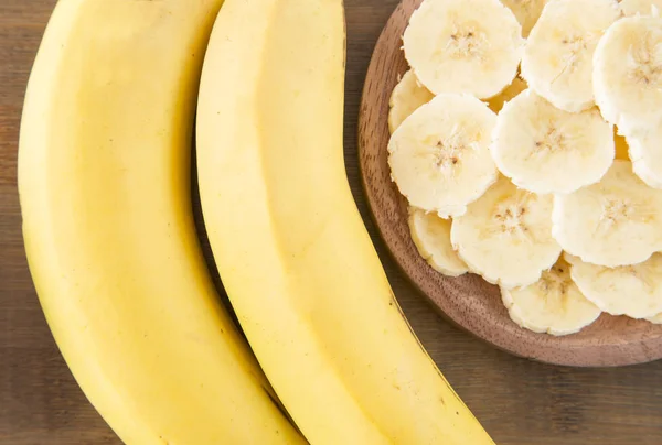 Slices banana on wooden background — Stock Photo, Image